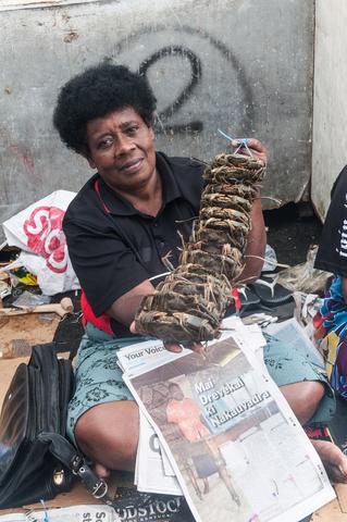 Fisher selling crabs at the market.
